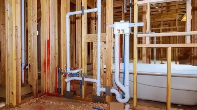 Plumbing rough-in with drain and supply pipes in new wall framing
