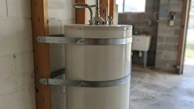 Tank water heater securely strapped to the wall in a garage